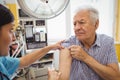 Female doctor giving an injection to a patient Royalty Free Stock Photo