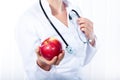 Female doctor giving red apple Royalty Free Stock Photo