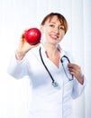 Female doctor giving red apple Royalty Free Stock Photo