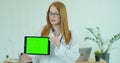 Female Doctor in glasses demonstrating digital tablet with chroma key in hospital, Portrait of woman in white gown with Royalty Free Stock Photo