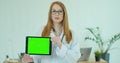 Female Doctor in glasses demonstrating digital tablet with chroma key in hospital, Portrait of woman in white gown with Royalty Free Stock Photo