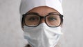 Female doctor in glasses looking straight at camera. Hard work, medical, epidemic concept Royalty Free Stock Photo