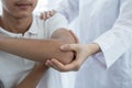 Female doctor hand doing physical therapy By extending the shoulder of a male patient Royalty Free Stock Photo