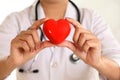 Female doctor hands holding a beautiful red heart shape Royalty Free Stock Photo