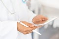 Female doctor` hands holding tablet computer and pen, use of electronic device in modern healthcare Royalty Free Stock Photo