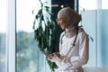 Female doctor in hijab works in modern clinic office, Muslim female doctor uses tablet computer, nurse in medical white Royalty Free Stock Photo