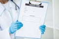 Female doctor hold clipboard pad and fill medical history list