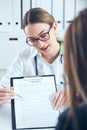 Female doctor hold clipboard showing document. Physical agreement form signature, disease prevention, ward round