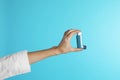 Female doctor holding asthma inhaler on color background. Medical object Royalty Free Stock Photo