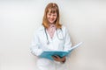 Female doctor holding blue clipboard and reading something Royalty Free Stock Photo