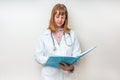 Female doctor holding blue clipboard and reading something Royalty Free Stock Photo