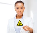 Female doctor holding boihazard caution sign Royalty Free Stock Photo