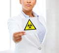 Female doctor holding boihazard caution sign Royalty Free Stock Photo