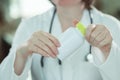 Female doctor holding bottle of dietary supplement Royalty Free Stock Photo