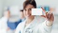 Female doctor holding a business card Royalty Free Stock Photo