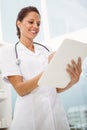 Female doctor holding clipboard in medical office Royalty Free Stock Photo