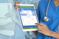 Female doctor holding digital tablet showing electronic medical record on screen Royalty Free Stock Photo