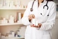 Female doctor holding in hand various drug boxes