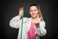 Female doctor holding measuring tape showing obscene gesture