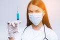 Female doctor holding medical injection syringe and stethoscope.Biological hazard. Epidemic of the Chinese coronavirus. Royalty Free Stock Photo