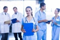 Female doctor holding medical report and smiling at camera Royalty Free Stock Photo