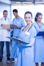 Female doctor holding medical report and smiling at camera Royalty Free Stock Photo