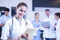 Female doctor holding medical report and smiling at camera Royalty Free Stock Photo