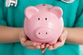 Female Doctor Holding Piggy Bank Royalty Free Stock Photo