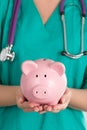 Female Doctor Holding Piggy Bank Royalty Free Stock Photo
