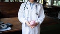 Female doctor is holding piggy bank, saving protection concept Royalty Free Stock Photo