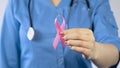 Female doctor holding pink ribbon close up, breast cancer awareness symbol Royalty Free Stock Photo