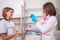 Female doctor holding preparing a syringe while talking to a nurse Royalty Free Stock Photo