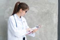 Doctor holding red clipboard and reading something. Healthcare and medical concept Royalty Free Stock Photo