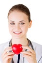 Female doctor holding red heart in hand. Royalty Free Stock Photo