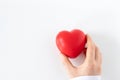 Female doctor holding red heart in hand isolated on white background, top view Royalty Free Stock Photo