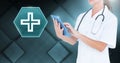 Female doctor holding tablet with medical cross interface hexagon icon