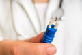 Female doctor is holding tweezers with a tick