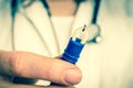 Female doctor is holding tweezers with a tick - retro style