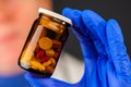 Female doctor holding unlabeled bottle of various pills and medi Royalty Free Stock Photo