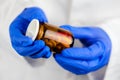 Female doctor holding unlabeled bottle of various pills and medi Royalty Free Stock Photo