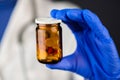 Female doctor holding unlabeled bottle of various pills and medi Royalty Free Stock Photo