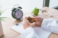 Female doctor holding unlabeled bottle of various pills and medication Royalty Free Stock Photo