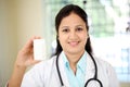Female doctor holding up a bottle of tablets Royalty Free Stock Photo