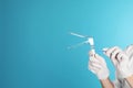 Female doctor holding vaginal speculum on color background, closeup view with space for text Royalty Free Stock Photo