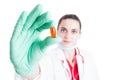 Female doctor holding vitamin pill in closeup