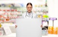 female doctor holding white board at pharmacy Royalty Free Stock Photo