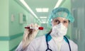 Female doctor in a hospital holding the COVID positive blood sample. Vaccine research concept