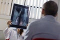 Female doctor in hospital with patient and x-rays