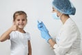 Female doctor injecting vaccine to girl Royalty Free Stock Photo