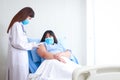 A female doctor injects an injection on the shoulder to an obese female patient to treat disease. Royalty Free Stock Photo